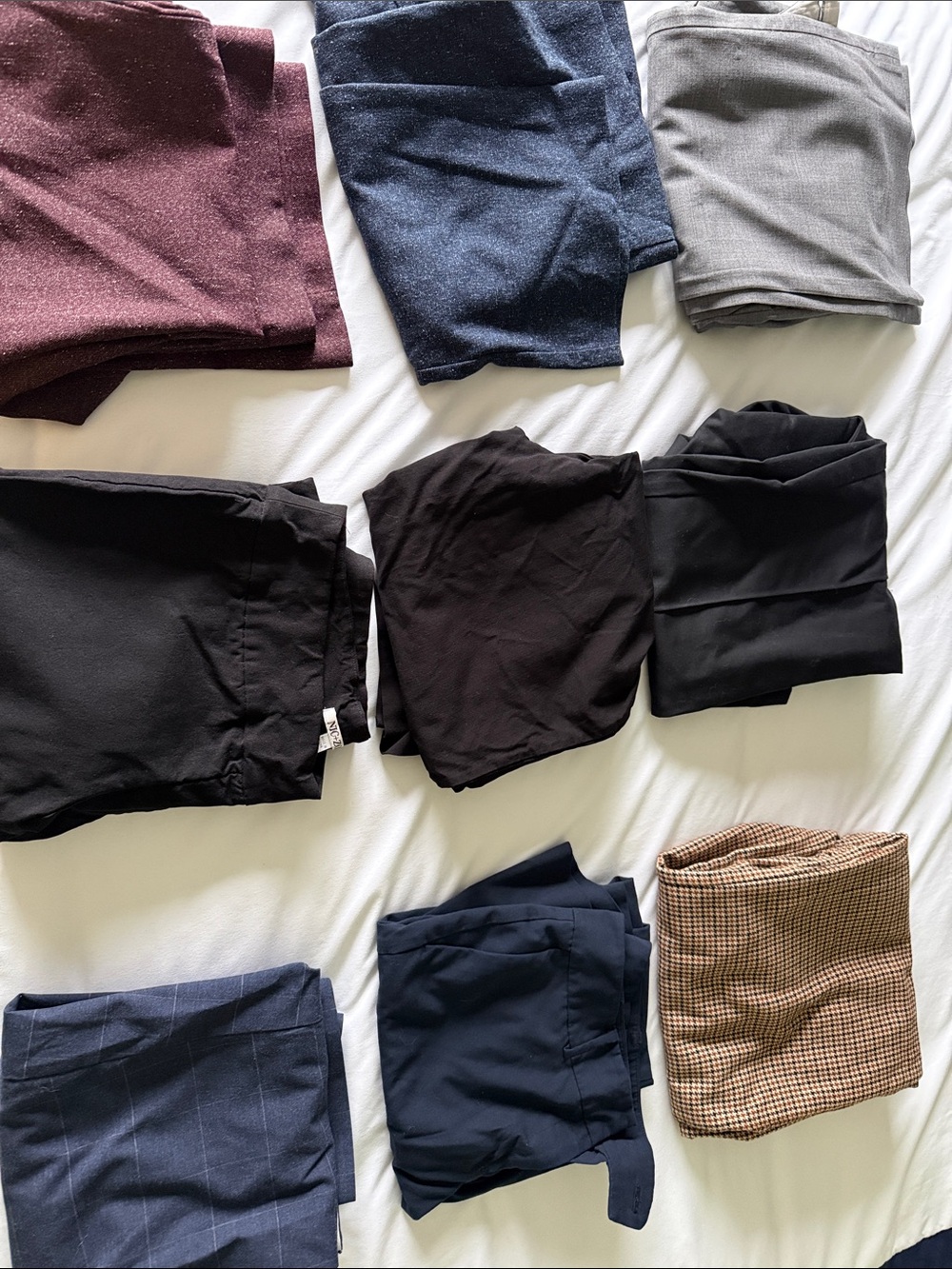 9 pairs of women’s petite work pants ranging size 8, 10 12. See details below.